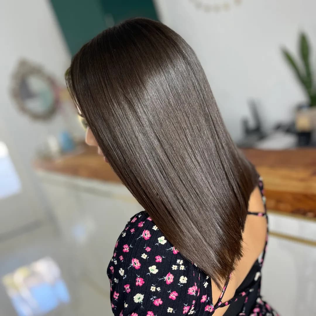 Shoulder-length straight brown hair seen in profile with a glossy finish