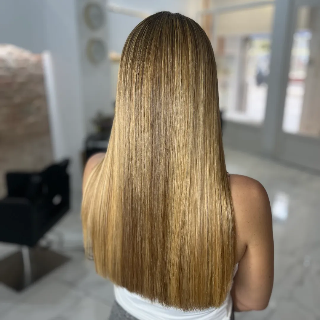 Back view of long, straight honey-blonde hair with perfectly even ends